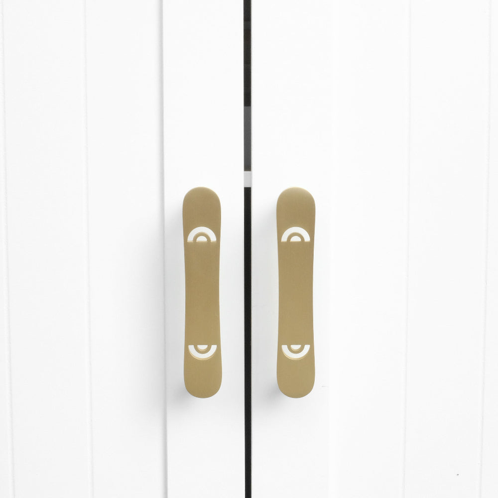 Horizon pulls in satin brass on modern white cabinet doors