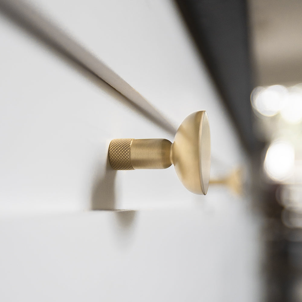 Knurled round knob in satin brass with faceted modern etching for style