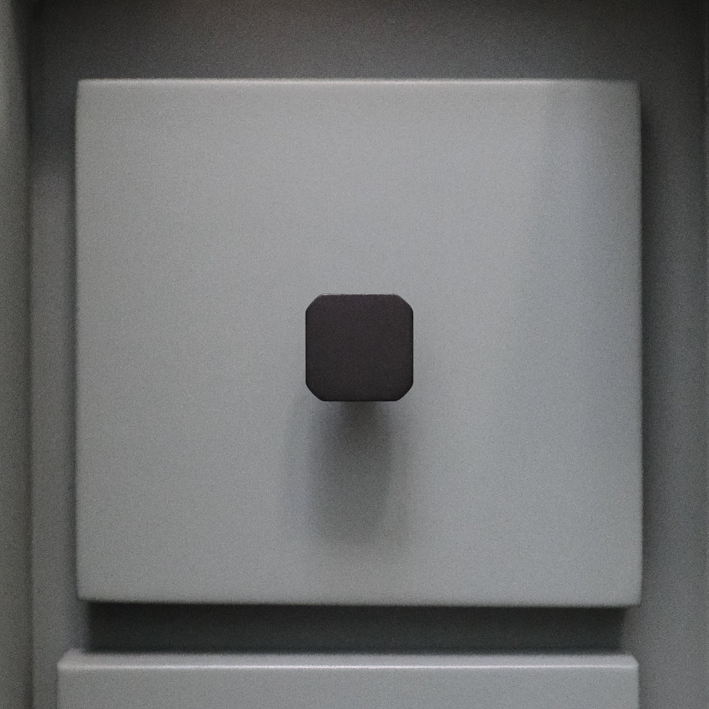 Mod cabinet knob in matte black and satin brass - forged smooth lines with angular design