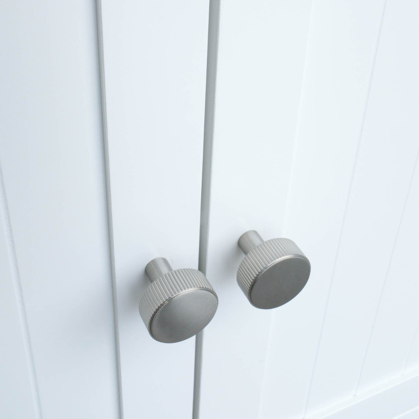 Ribbed knobs in satin nickel with industrial grooves and etched design