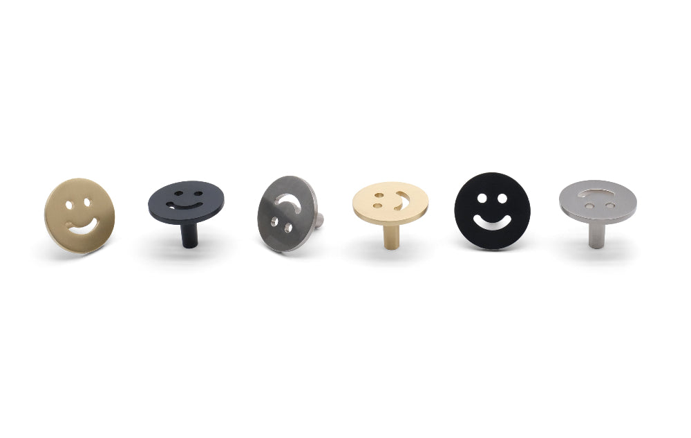 Smiley knobs in matte black, satin nickel, and satin brass - modern cabinet knobs with playful curves