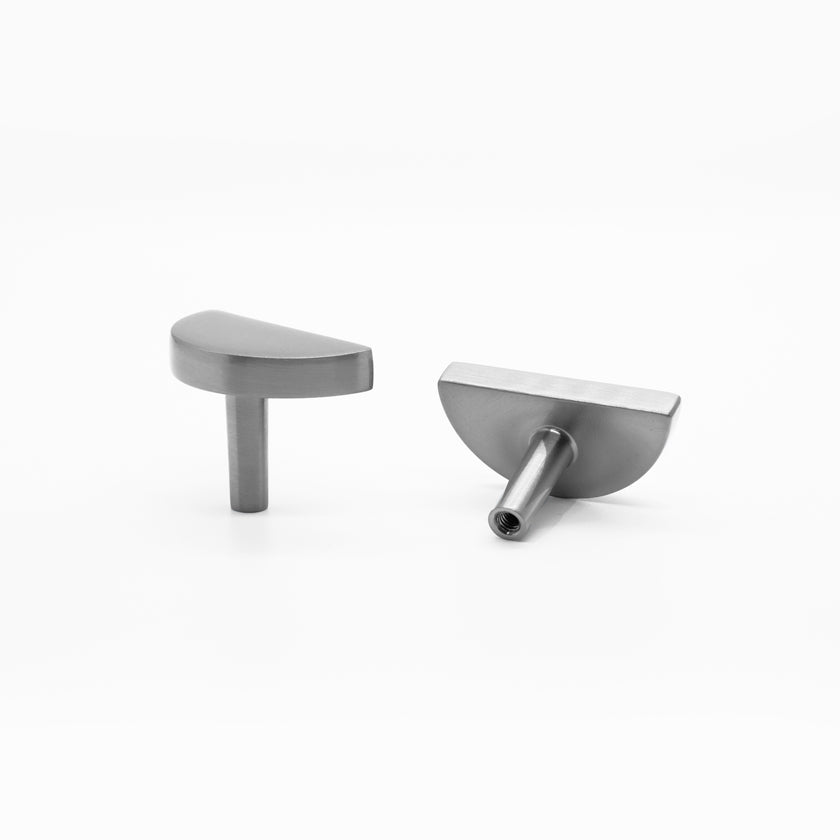 Half moon cabinet knob with subtle curves and geometric shape in satin nickel