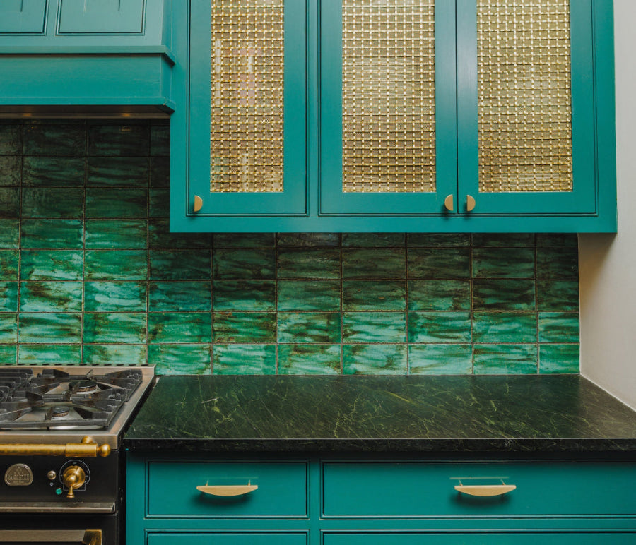 Half moon knobs and pulls in satin brass for blue tone modern cabinets