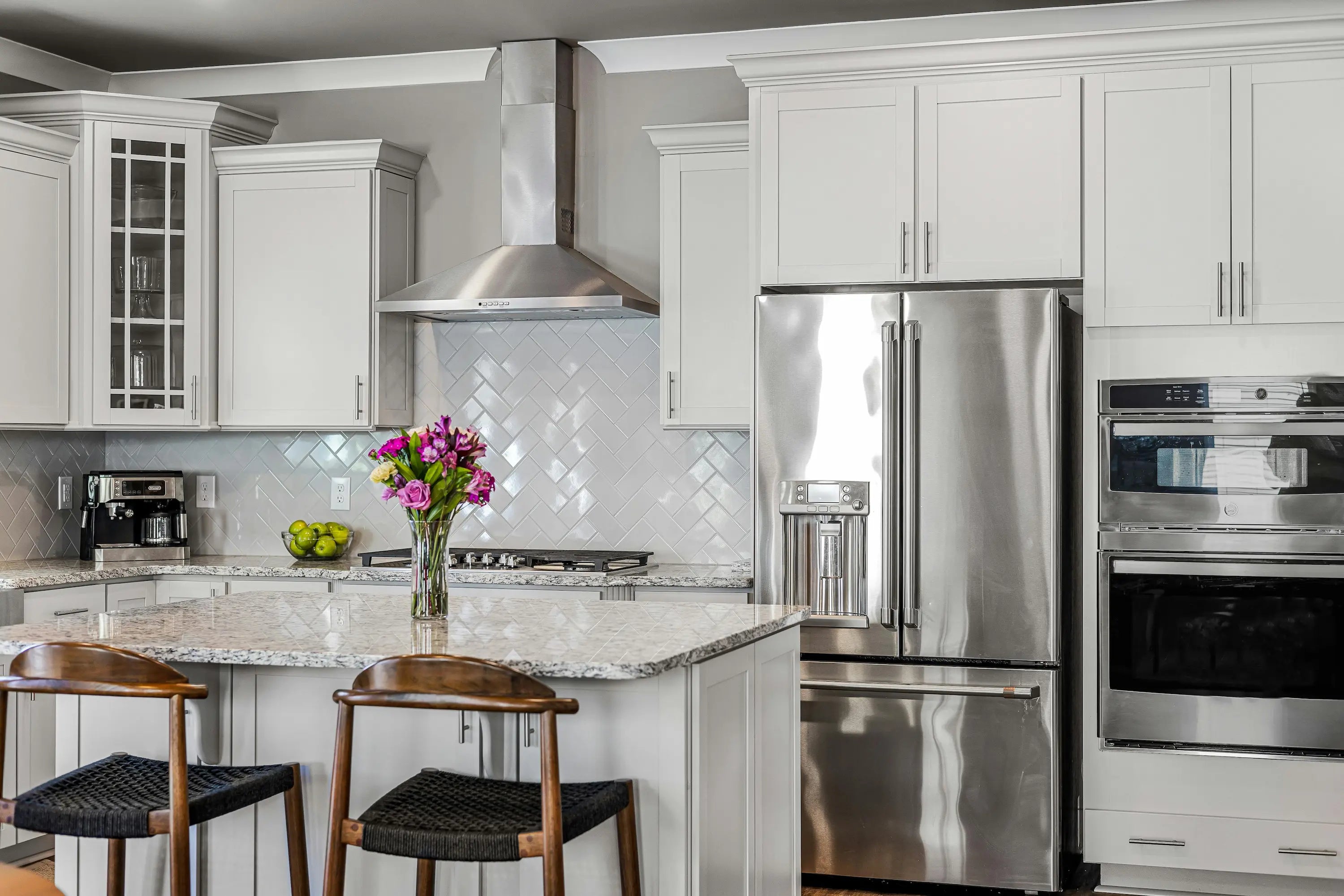 Modern cabinet pulls in brushed nickel finish on white contemporary kitchen doors and drawers