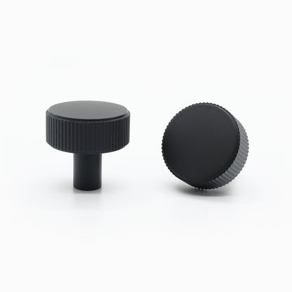 Industrial designed ribbed cabinet knob in matte black with smooth round top