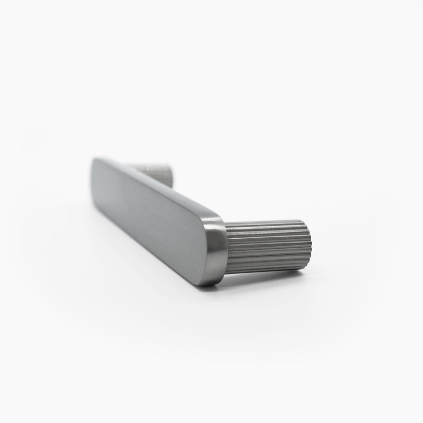 Side view of ribbed cabinet pull in satin nickel with textured stems and a flat face