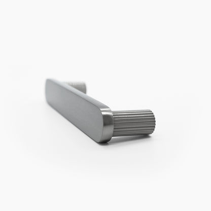 Side view of ribbed cabinet pull in satin nickel with textured stems and a flat face