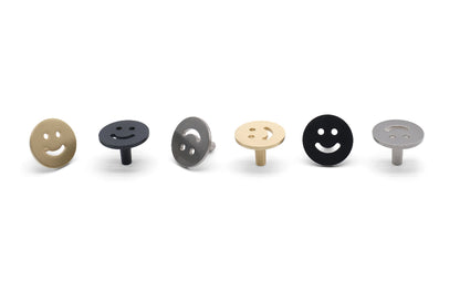 Smiley knobs in matte black, satin nickel, and satin brass - modern cabinet knobs with playful curves